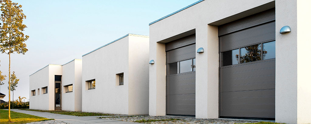 White building with brown garagedoors header