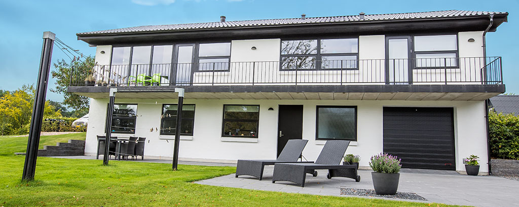 Black garage door on white building header with new logo